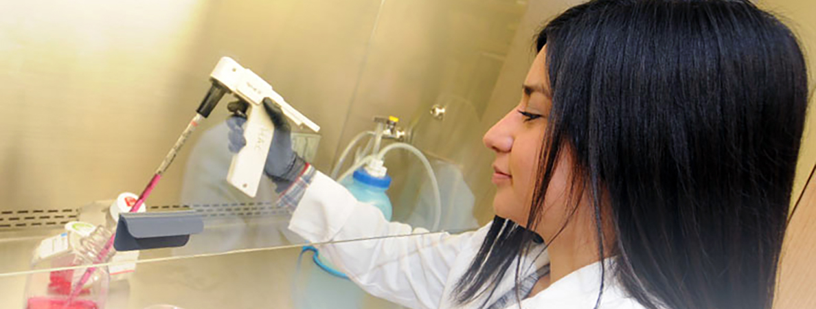 SMB News banner, a young women doing lab work