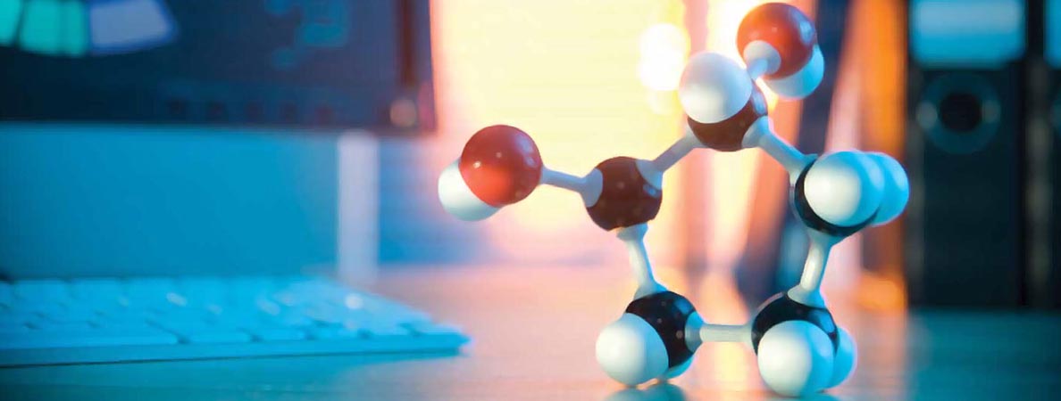 SMB Events banner, image of a model of a molecule next to a computer